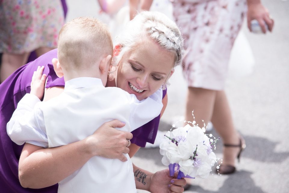 One of the bridesmaids greeting a slightly smaller guest!