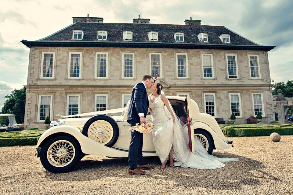 Kate and Adam kissing through the car at this Leicestershire venue.