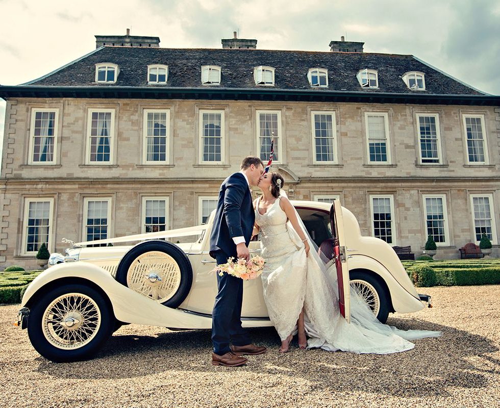 Kate and Adam kissing through the car at this Leicestershire venue.