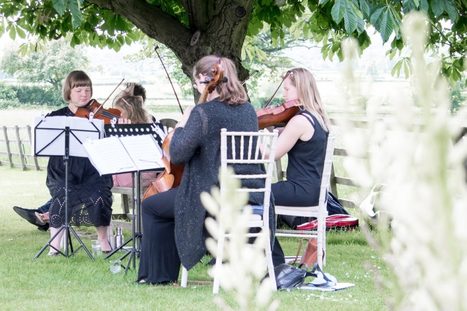 The two had violinists in the garden as canapés and drinks were handed out.