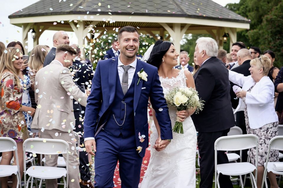 The happy couple walking back down the aisle.