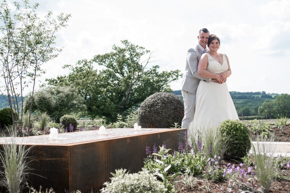 The happy couple in the beautifully manicured gardens.