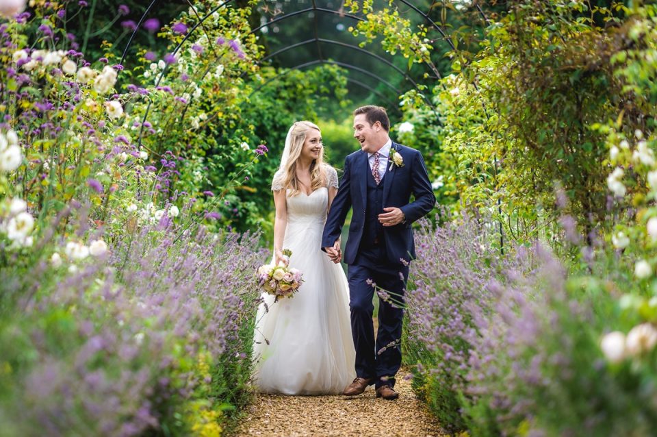 The happy couple walking down another aisle, hand in hand and now husband and wife.