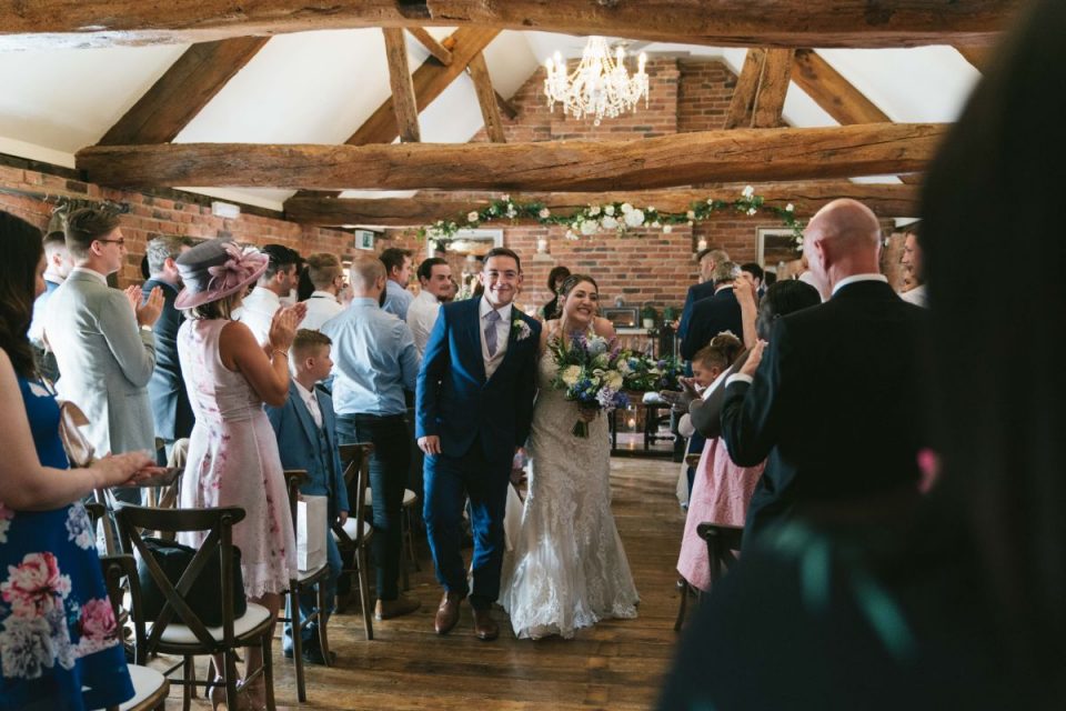 The lovely couple walking back down the aisle!