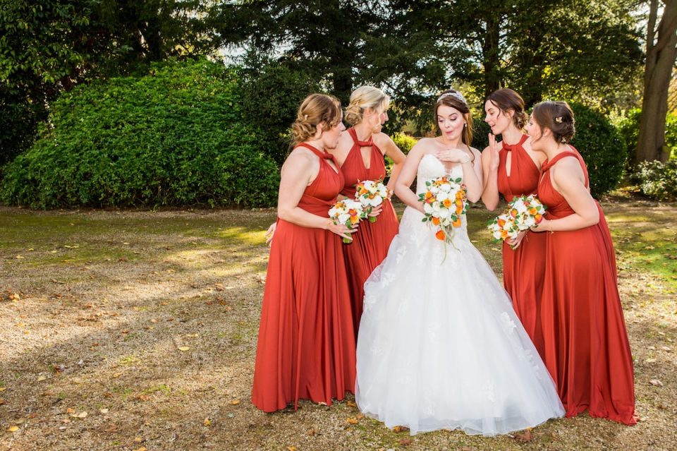 Loving the bright orange bridesmaids!