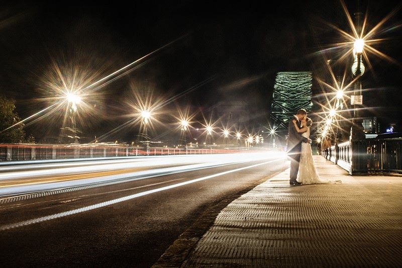 The photographer used a slow shutter speed to make the car lights a blur and wonderfully capture the couple in front of Tyne Bridge.