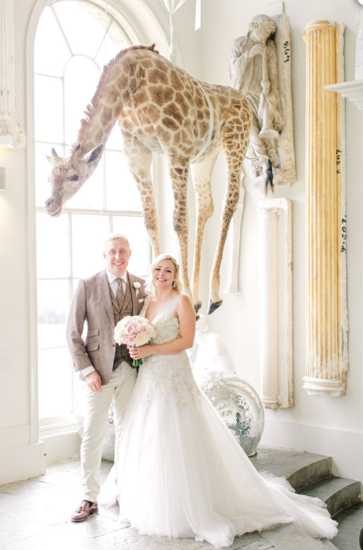 Where else can you get married and have a giraffe in your pictures?!